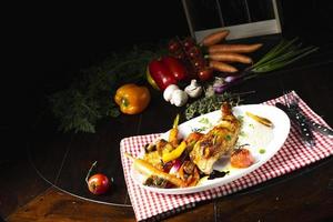 Rustic fried chicken legs with assorted vegetables and rice photo