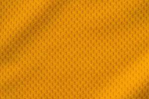 Orange color sports clothing fabric jersey football shirt texture top view photo