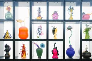 Tacoma, Washington, USA. March 2021. Art objects made of glass on the shelves of the museum. Colorful vases photo