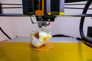 Modern 3D printer printing figure close-up macro 3d printer prints a vertebra photo