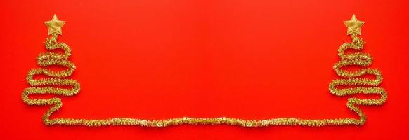 Golden christmas tree on red background new year holiday celebration concept photo