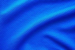 Blue football jersey clothing fabric texture sports wear background, close up top view photo