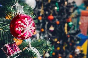 Decorated Christmas tree with colorful bauble on sparkling bokeh light blurred background photo