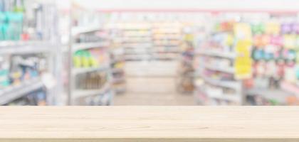 mesa de madera vacía con supermercado tienda de comestibles fondo desenfocado borroso con luz bokeh para la exhibición de productos de montaje foto