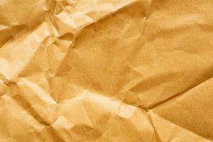 Brown crumpled paper recycled kraft sheet texture background photo