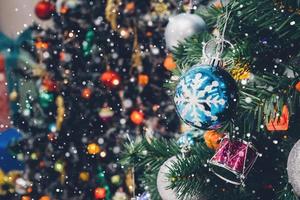 Decorated Christmas tree with colorful bauble on sparkling bokeh light blurred background photo