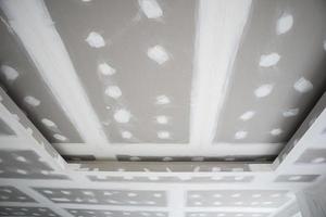 ceiling gypsum board installation at construction site photo