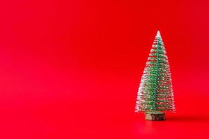 Christmas tree on red background new year  holiday celebration concept photo