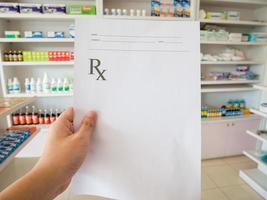 pharmacist with prescription at the pharmacy photo