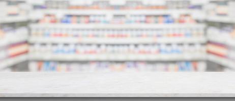 Empty white marble counter top with blur pharmacy drugstore shelves background photo