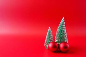 Christmas tree and baubles on red background new year  holiday celebration concept photo