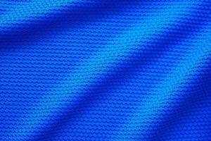 Blue football jersey clothing fabric texture sports wear background, close up top view photo