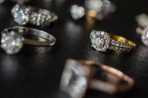 Jewelry diamond rings set on black background close up photo