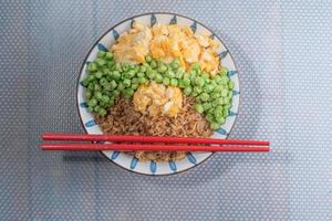 Egg fried rice and bean in bowl on white table. photo