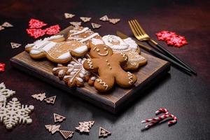 Christmas decoration elements as well as gingerbread on a brown concrete background photo