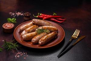 Roasted sausages grill with spices and herbs with salt and pepper photo