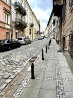 Narrow old street with paving stones, European street photo