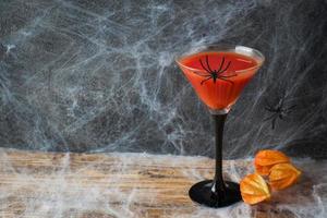 Bloody Mary cocktail, pumpkin with bats and spiders for Halloween, selective focus Copy space photo