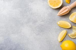 Ripe lemon and lemon slices on grey background with copy space. photo