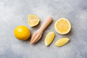 Ripe lemon and lemon slices on grey background with copy space. photo