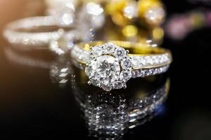 anillos de diamantes de joyería con una reflexión sobre fondo negro foto