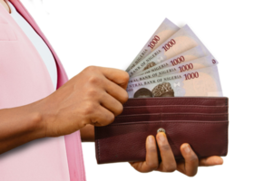 fair Female Hand Holding brown Purse With Nigerian naira notes, hand removing money out of purse isolated on transparent background png