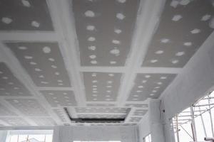 ceiling gypsum board installation at construction site photo