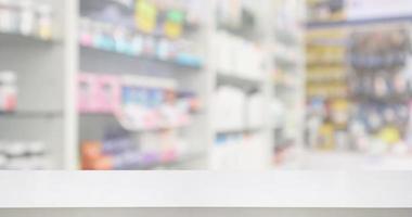 Pharmacy drugstore counter with medicine and vitamin supplement on shelves blur abstract background for montage healthcare product display photo