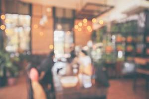 Restaurant cafe or coffee shop interior with customer blur abstract vintage style bokeh light for montage product display background photo