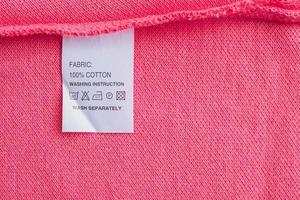 White laundry care washing instructions clothes label on cotton shirt photo