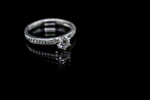 Close up Jewelry diamond ring on black background with reflection photo