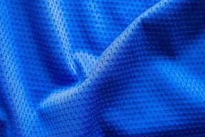 Blue color fabric sport clothing football jersey with air mesh texture background photo