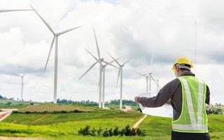 Engineer worker at wind turbine power station construction site photo