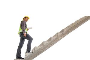 Asian business man construction engineer hold blueprint paper walking up stairway isolated on white background with clipping path, career growth success concept photo