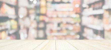 Wood table top with Abstract supermarket grocery store refrigerator blurred defocused background with bokeh light photo