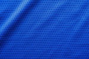 Blue color fabric sport clothing football jersey with air mesh texture background photo