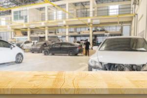 Mesa de madera vacía con centro de servicio de automóviles taller de reparación de automóviles fondo borroso