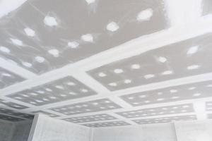 ceiling gypsum board installation at construction site photo