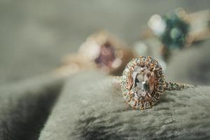 Jewelry luxury diamond ring closeup on fabric texture background photo