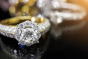 Jewelry diamond rings with reflection on black background photo