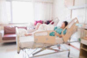 Abstract blur Patient on bed in Hospital Room interior for background photo