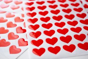 Close up red heart sticker on white paper photo