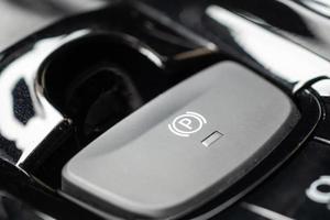 electronic handbrake button in luxury modern car photo