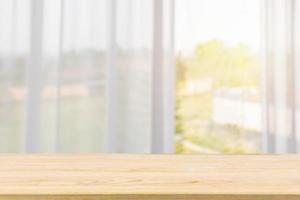 Empty wood table top with window curtain abstract blur background for product display photo