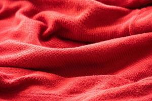 closeup red knitted woolen fabric texture background photo