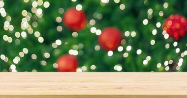 Empty wood table top with Abstract blur Christmas tree with decoration bokeh light background for product display photo