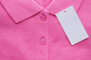 Blank white clothes tag label on new shirt photo