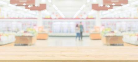 Wood table top with supermarket grocery store blurred defocused background with bokeh light for product display photo