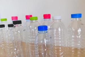 set of many plastic bottle on wood table, recycling concept photo