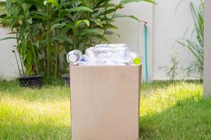 plastic bottles in brown recycle garbage box photo